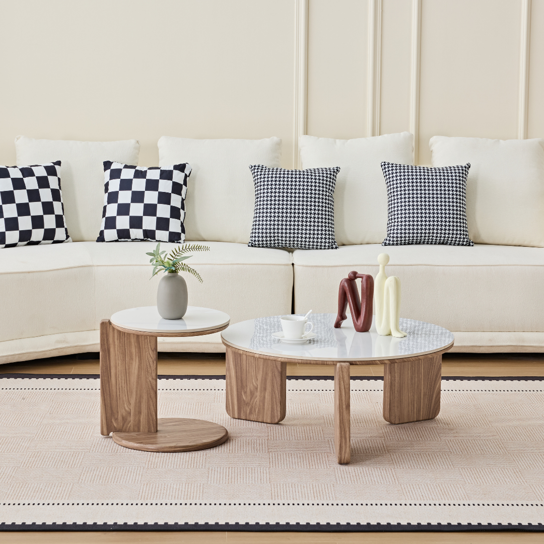 Elnor white ceramic marble nesting coffee table set with wood-textured base in a modern living room