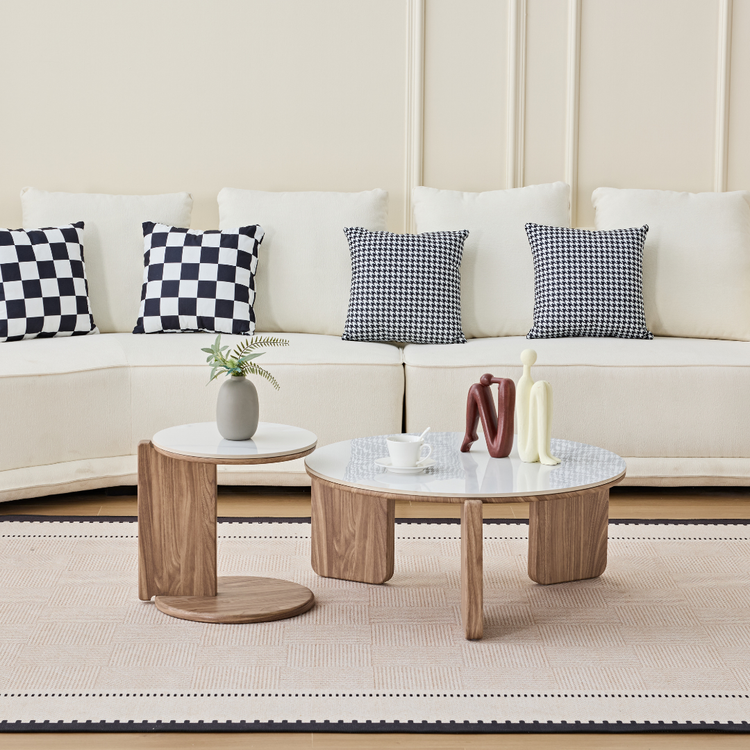 Elnor white ceramic marble nesting coffee table set with wood-textured base in a modern living room