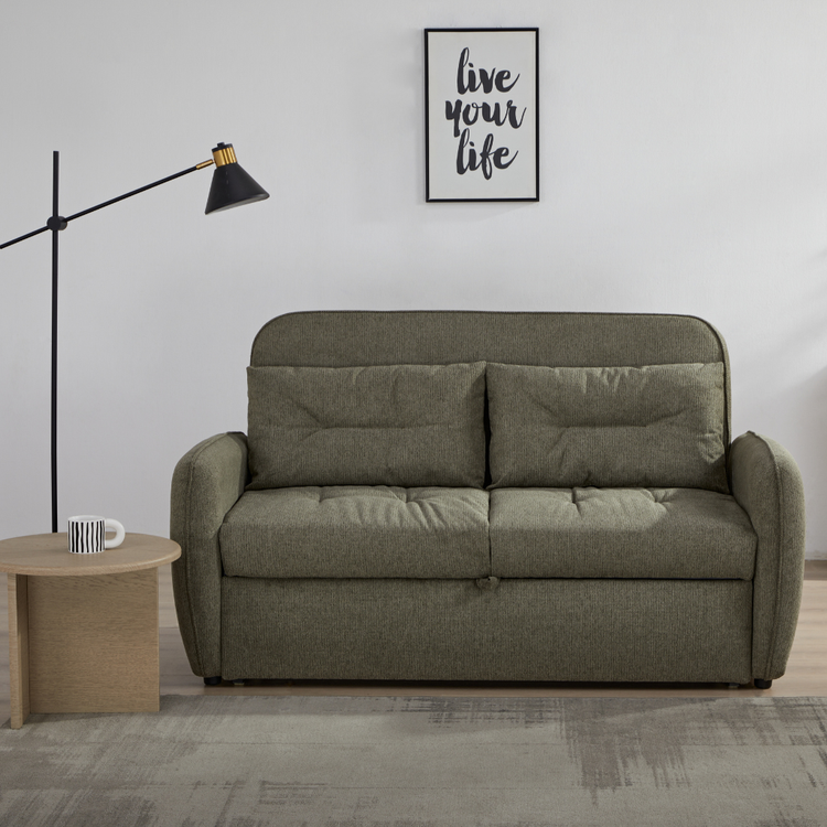 Enzo Sofa Bed Earthy Green showing compact 2-seater olive green fabric sofa styled with a modern floor lamp at NZ Furniture Warehouse