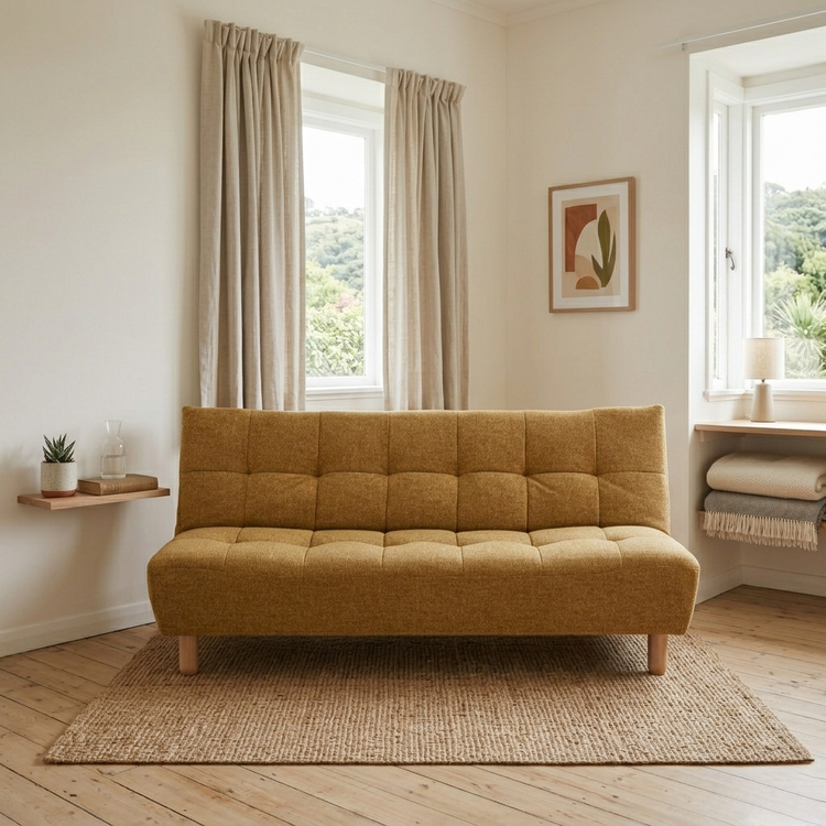 Laro Sofa Bed showing the armless mustard yellow sofa bed styled beautifully in a warm, minimalist Scandi living room setup