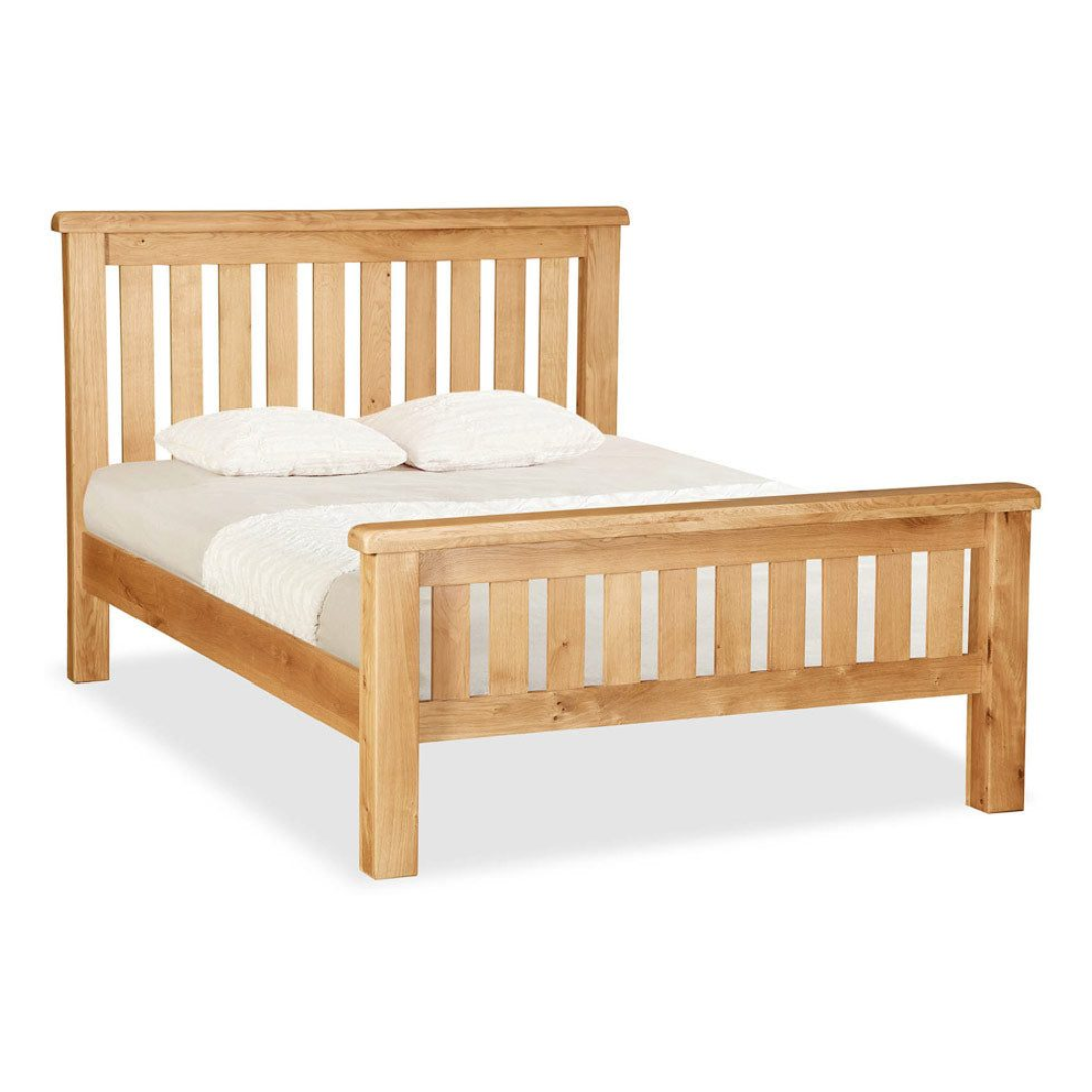 Bedframe in Solid Oak Wood with natural finish and classic slatted headboard and footboard.