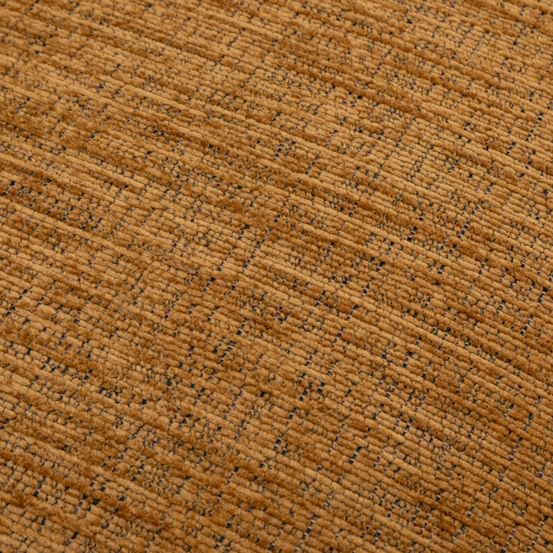 Close-up of a textured mustard fabric surface on the Orbit Swivel Chair.