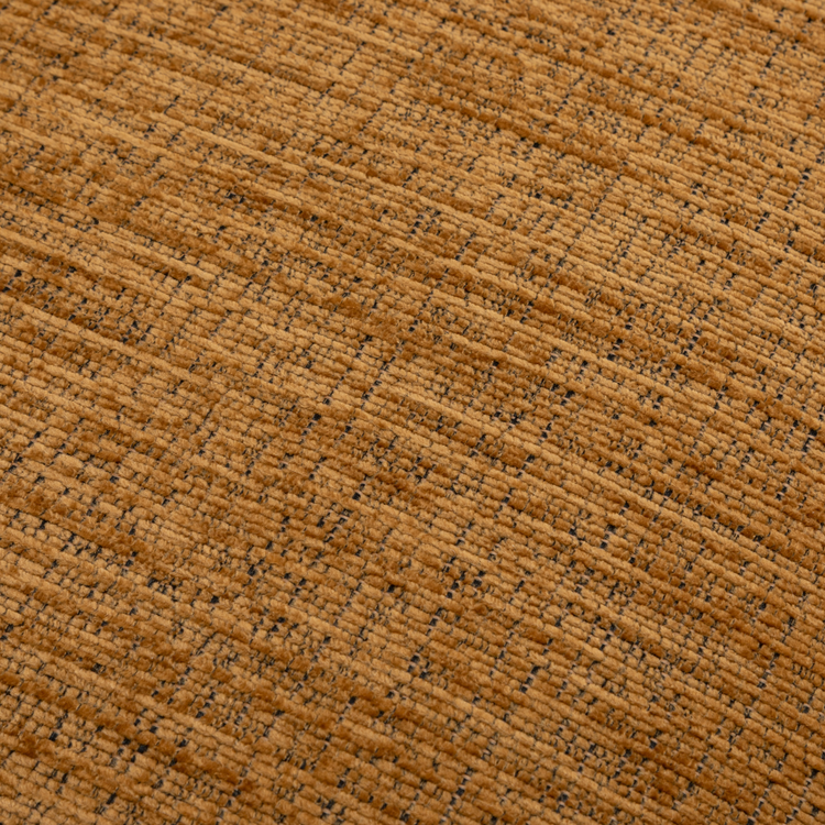 Close-up of a textured mustard fabric surface on the Orbit Swivel Chair.