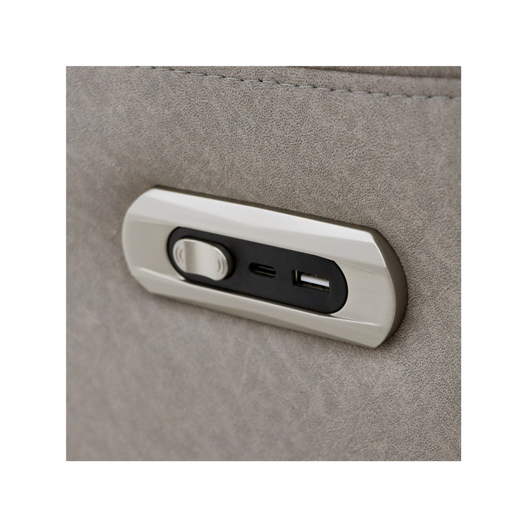 Close-up of the electric recliner control panel with USB and USB-C ports on the side of the Skara chair.